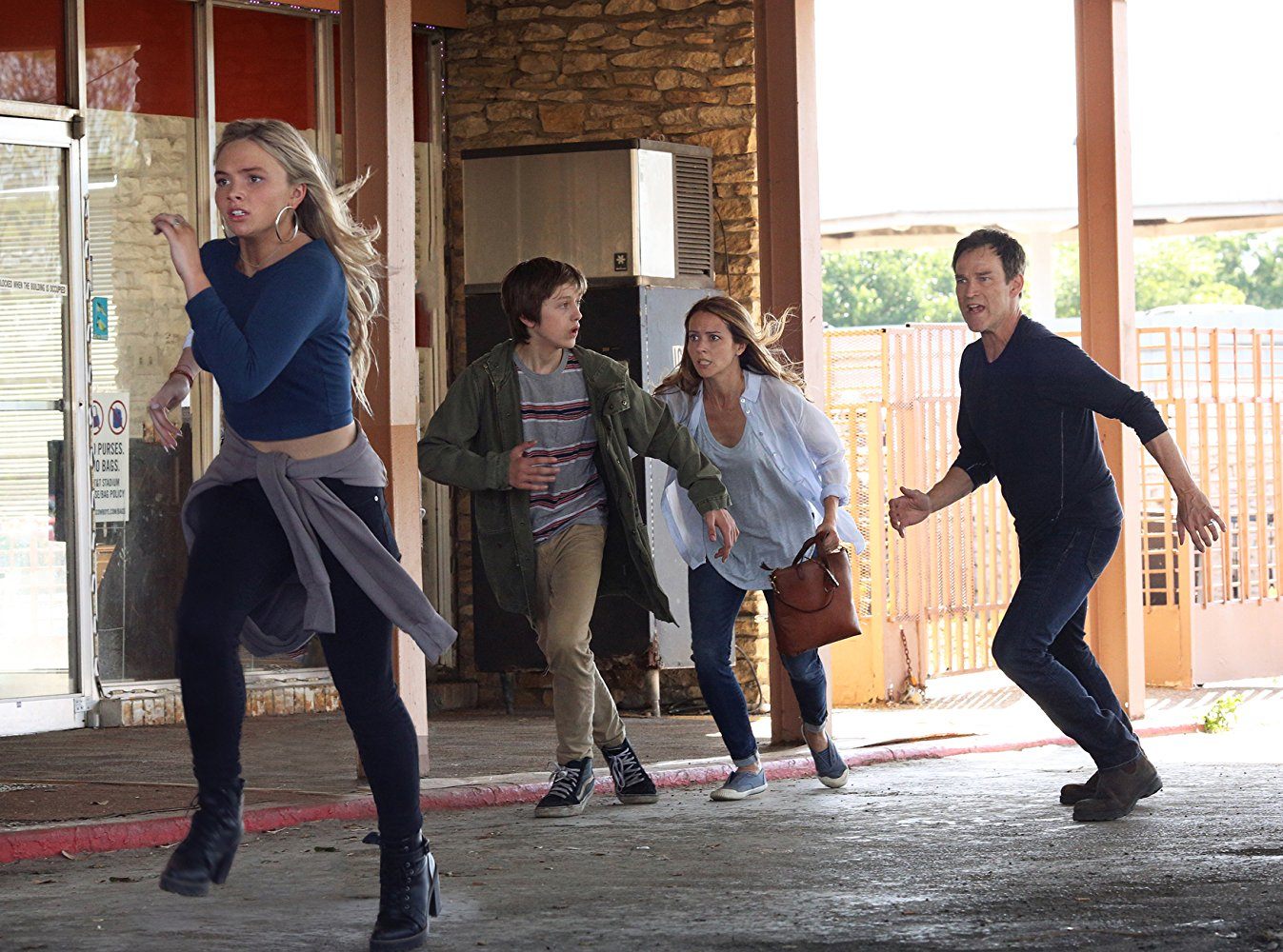 Lauren, Andy, Caitlin, and Reed Strucker running in front of a building