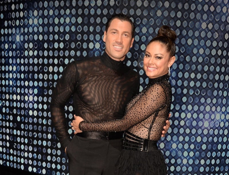 Maksim Chmerkovskiy and Vanessa Lachey smile and hug while wearing black costumes Maksim Chmerkovskiy and Vanessa Lachey smile and hug while wearing black costumes