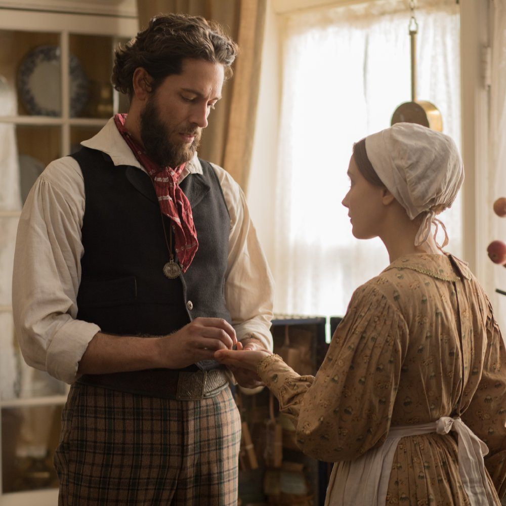 Sarah Gadon and Zachary Levi play a couple holding hands while standing in a kitchen. Sarah Gadon and Zachary Levi play a couple holding hands while standing in a kitchen.