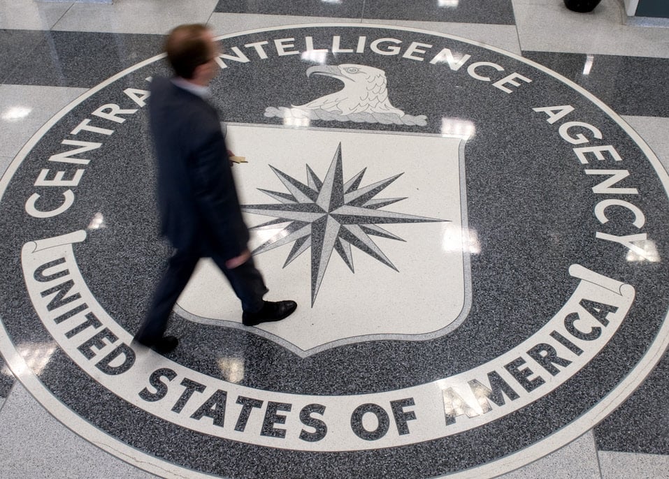 A man crosses the Central Intelligence Agency logo