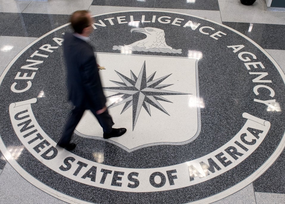 A man crosses the Central Intelligence Agency logo A man crosses the Central Intelligence Agency logo