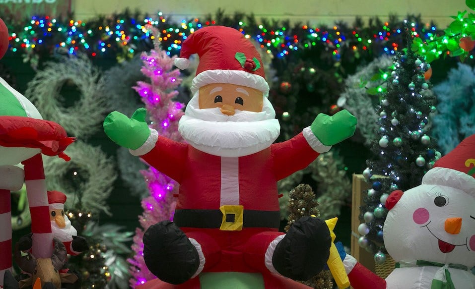A inflatable Father Christmas is seen in the seasonal retail factory outlet