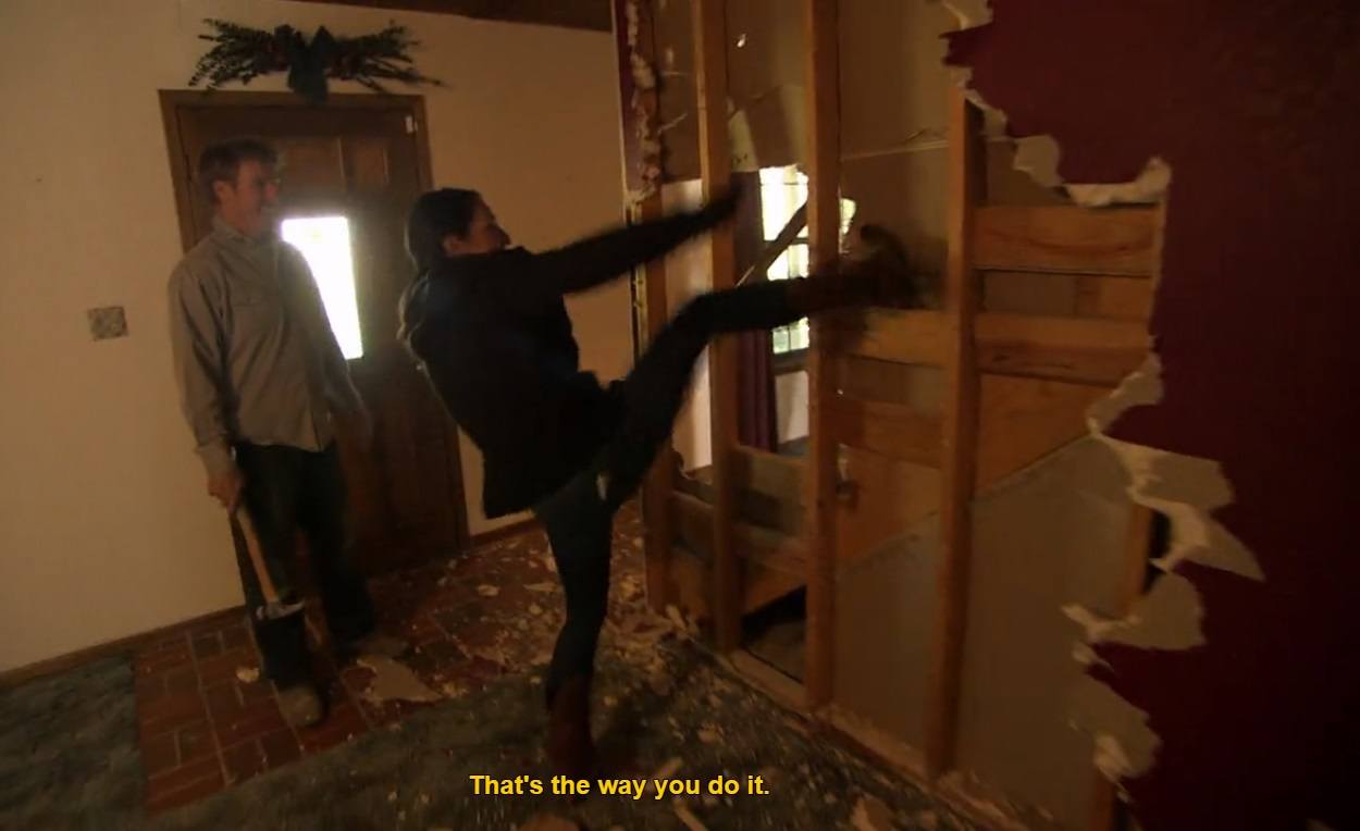 Joanna kicks down wall