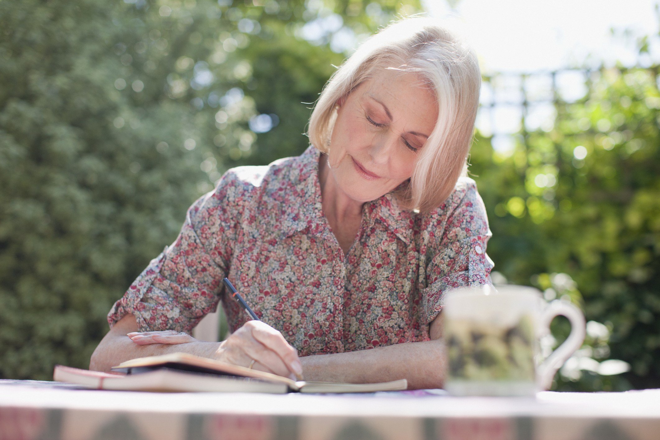 Woman writing at patio table