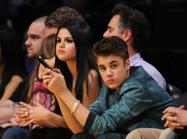 Justin Bieber and Selena Gomez watch the game between the San Antonio Spurs and the Los Angeles Lakers at Staples Center on April 17, 2012 in Los Angeles, California.