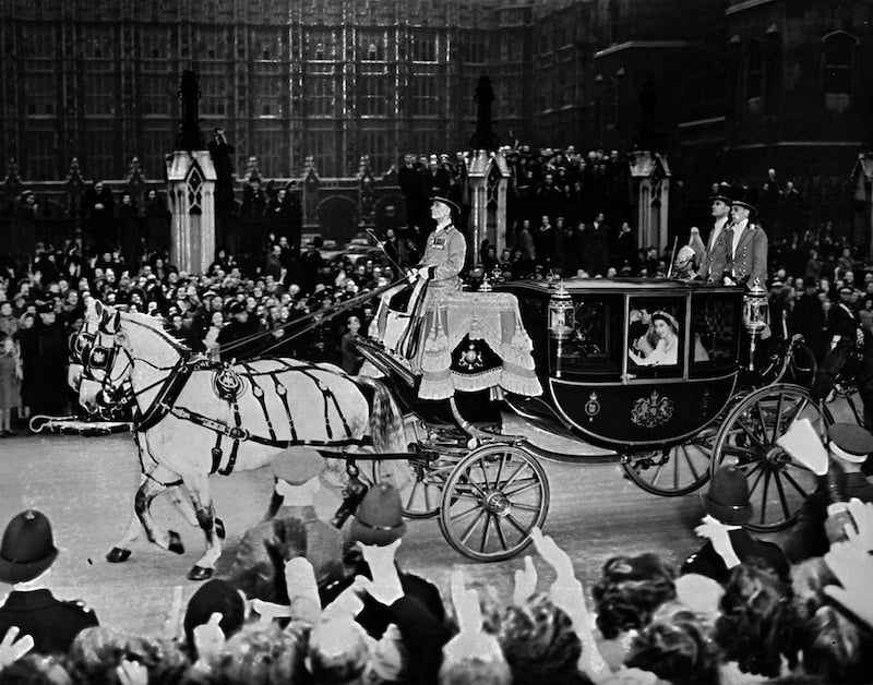 Queen Elizabeth and husband Prince Philip are cheered by the crowd after their wedding ceremony.