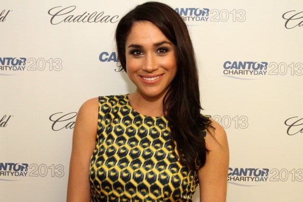 meghan markle at a charity event in yellow and black meghan markle at a charity event in yellow and black