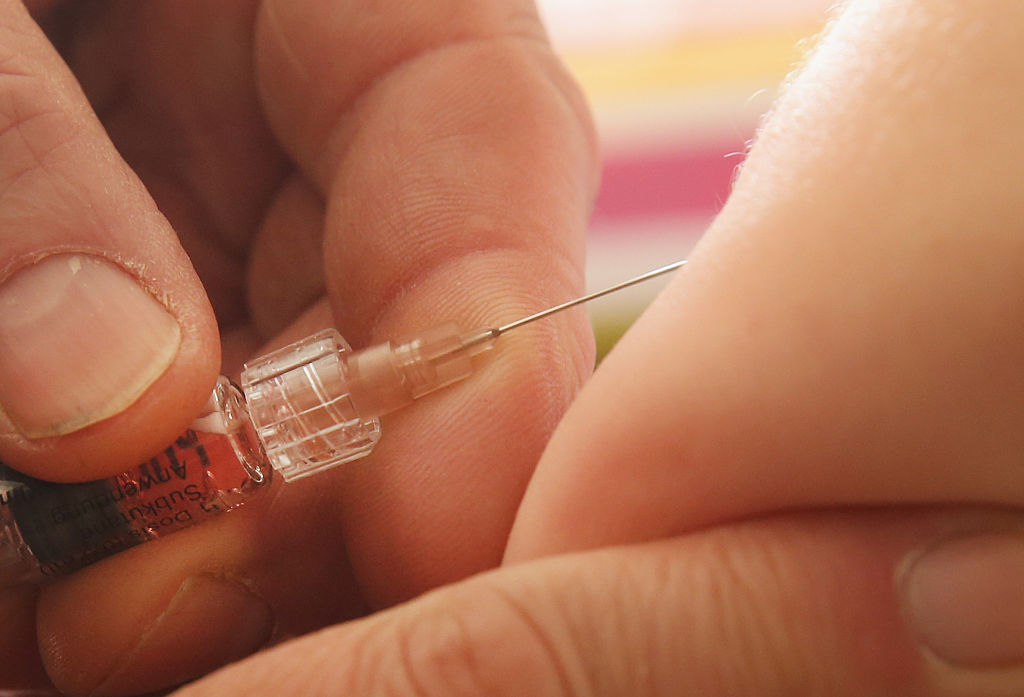 a vaccine gets injected into an arm a vaccine gets injected into an arm