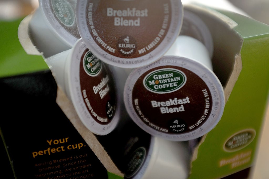 a box of K-Cups open and spilling out the cups a box of K-Cups open and spilling out the cups