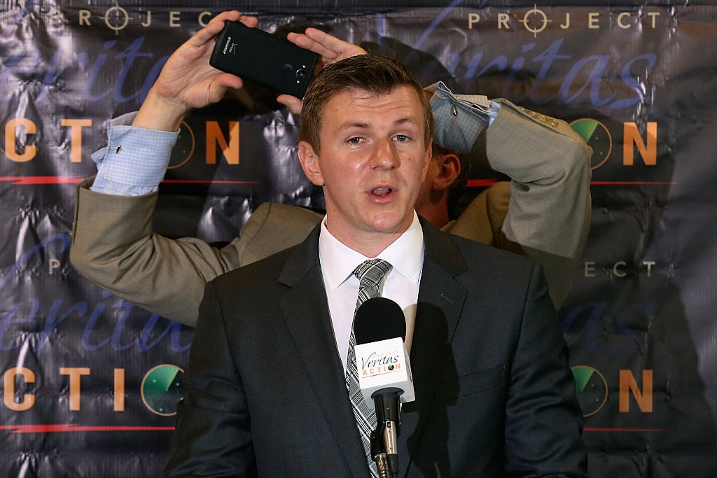 james o'keefe speaking to reporters in a dark suit james o'keefe speaking to reporters in a dark suit