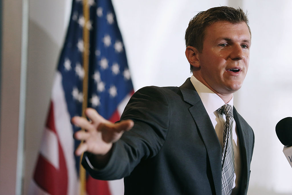 james o'keefe gestures in a suit in front of an american flag james o'keefe gestures in a suit in front of an american flag