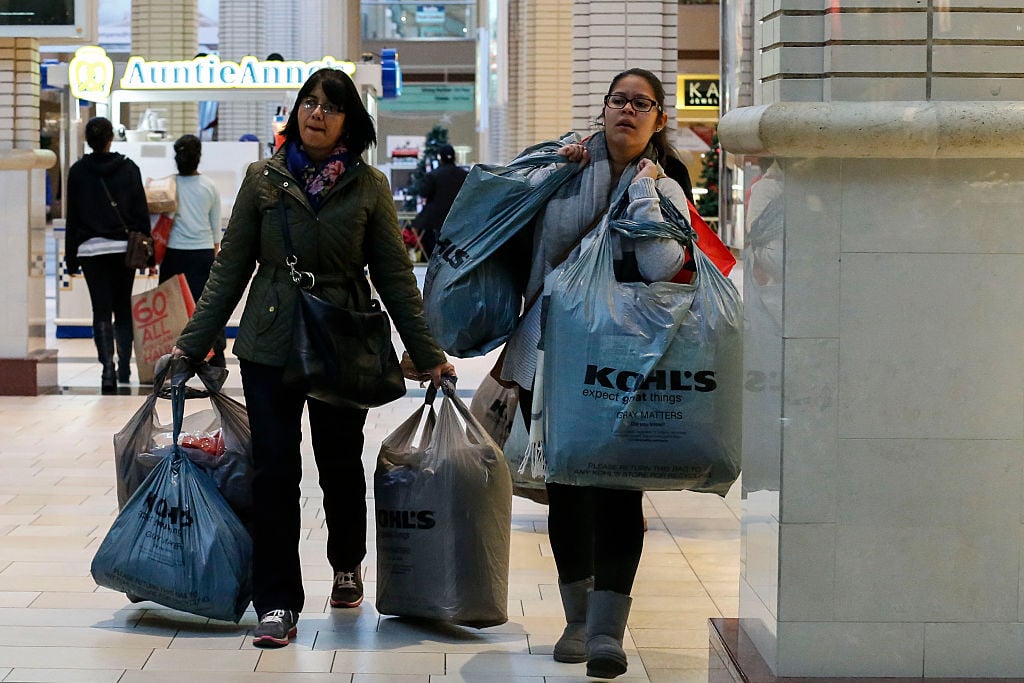 shoppers carry bags during Black Friday