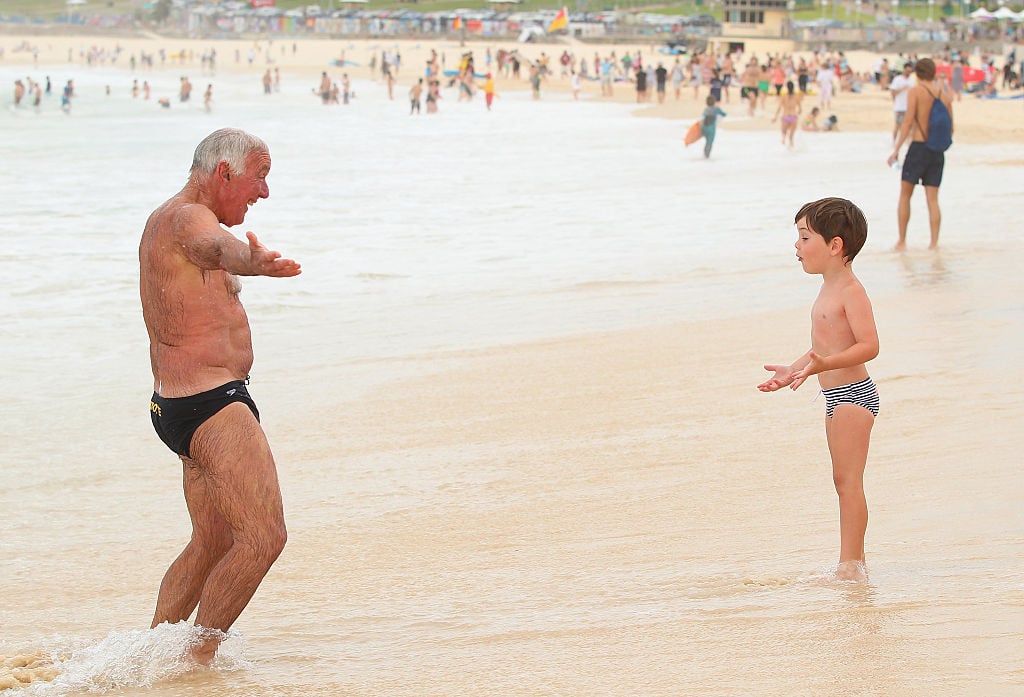 a grandfather and grandson on a beach a grandfather and grandson on a beach