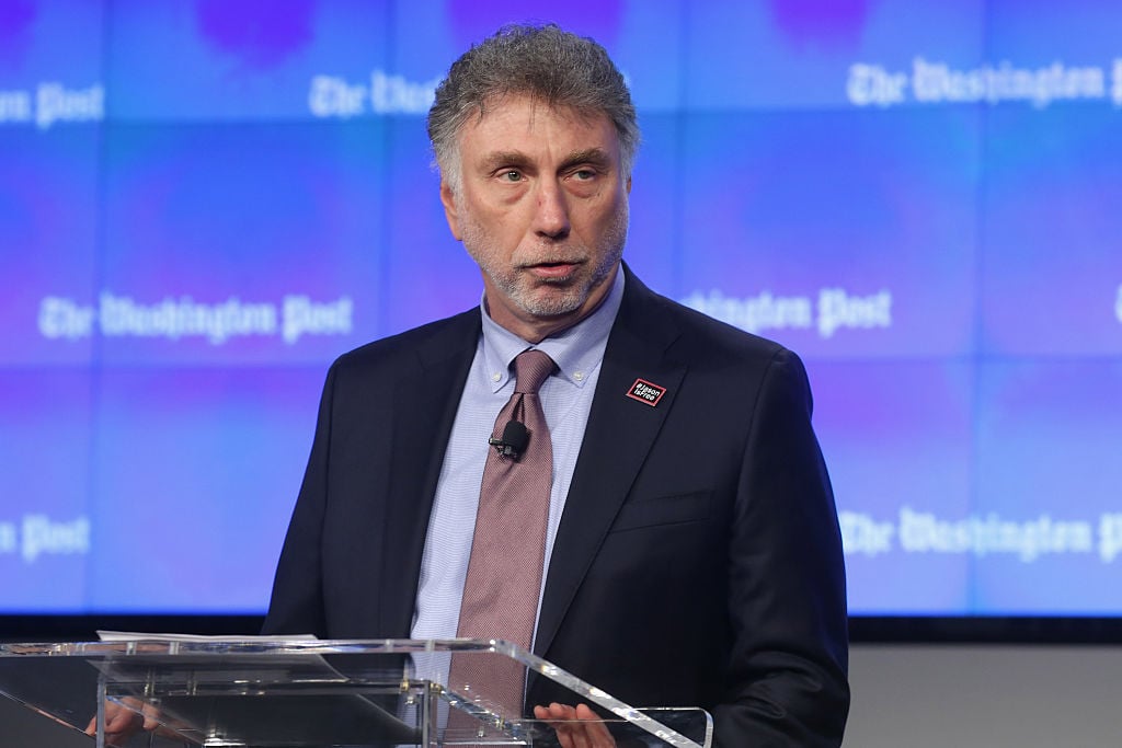 martin baron in a suit and tie in front of a blue background martin baron in a suit and tie in front of a blue background