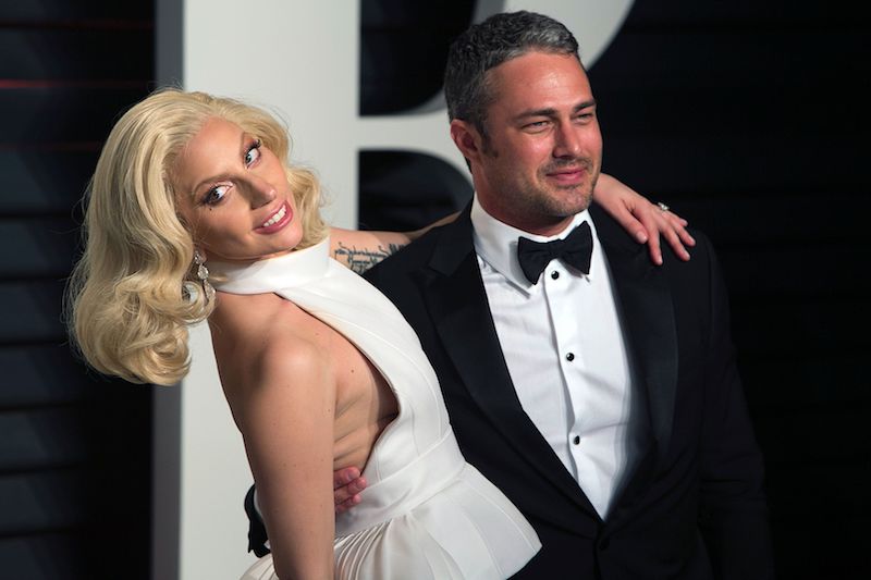 US singer Lady Gaga and her partner US actor Taylor Kinney pose as they arrive to the 2016 Vanity Fair Oscar Party US singer Lady Gaga and her partner US actor Taylor Kinney pose as they arrive to the 2016 Vanity Fair Oscar Party