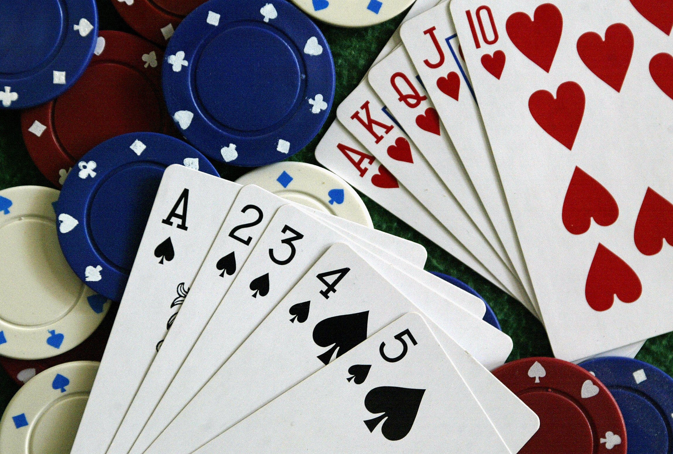 Chips, a deck of cards and a green mat.