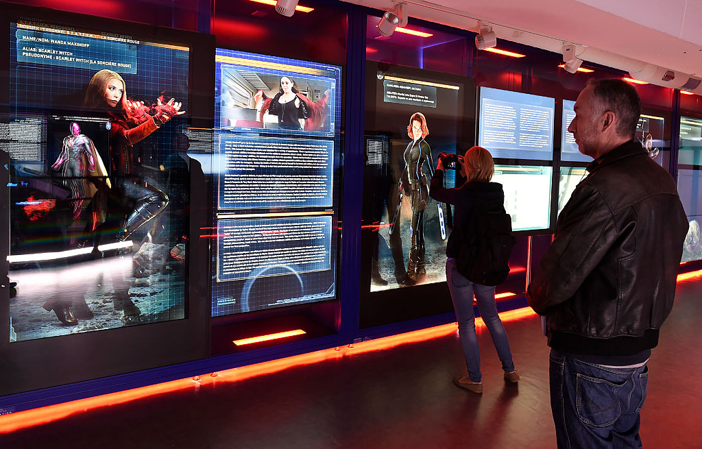 visitors look at an exhibit on scarlet witch and black widow visitors look at an exhibit on scarlet witch and black widow