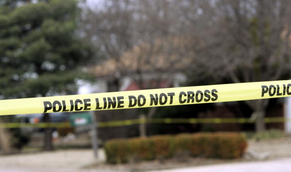 police tape across a blurred outdoor landscape