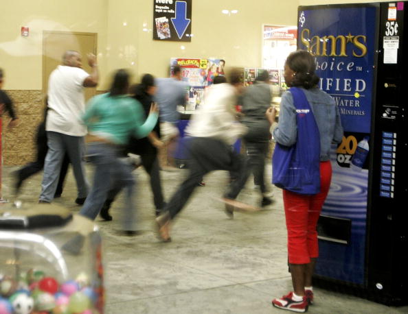 shoppers run past Black Friday signs shoppers run past Black Friday signs