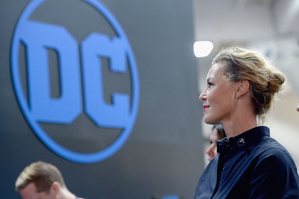a woman looks at a DC logo a woman looks at a DC logo