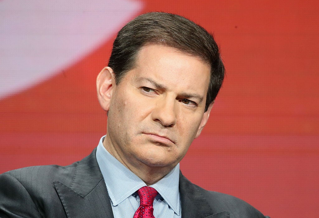 mark halperin in a suit and a red tie against a red background