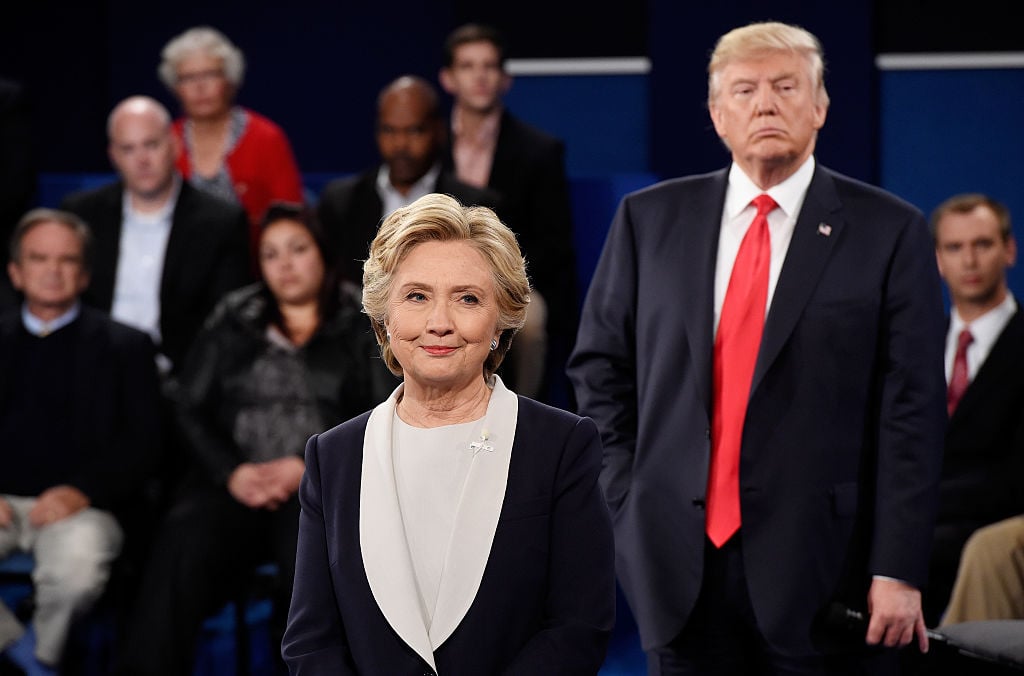 trump stands behind clinton during the third presidential debate with people behind him trump stands behind clinton during the third presidential debate with people behind him