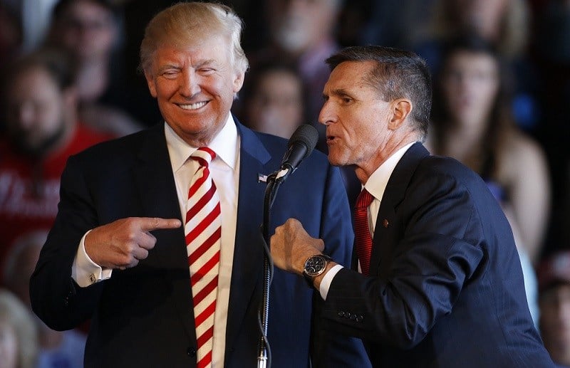 Republican presidential candidate Donald Trump (L) jokes with retired Gen. Michael Flynn as they speak at a rally at Grand Junction Regional Airport on October 18, 2016 in Grand Junction Colorado.