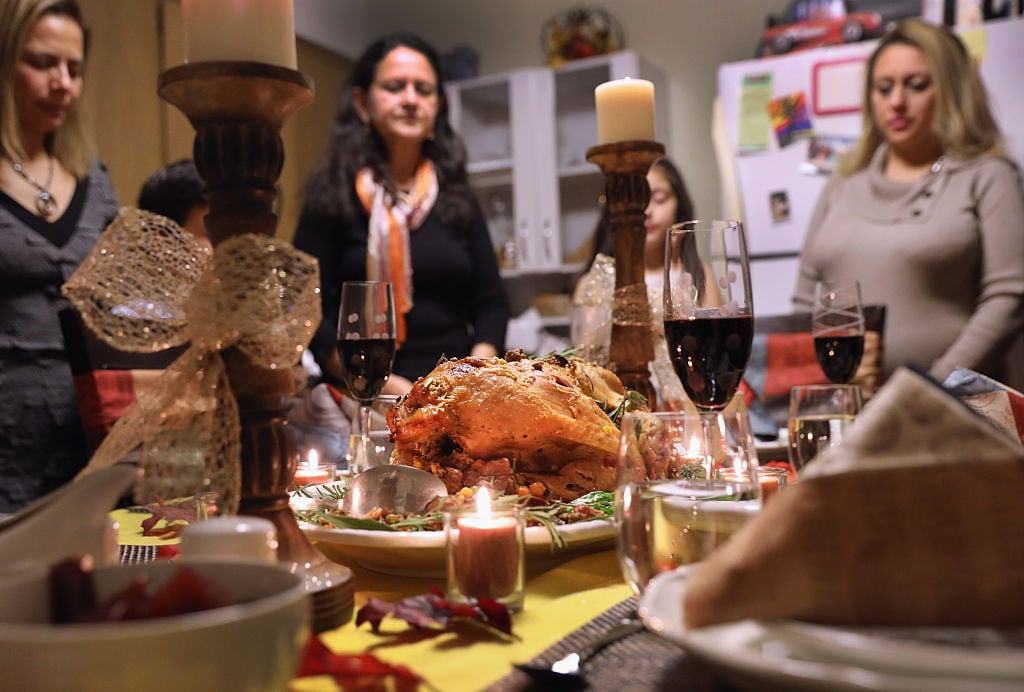 a thanksgiving turkey and settings with a woman and candles a thanksgiving turkey and settings with a woman and candles