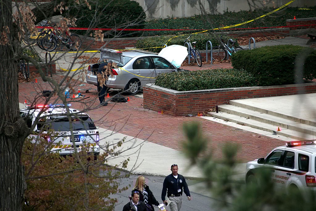 the scene of an Ohio State terrorist attack with a silver car and police tape the scene of an Ohio State terrorist attack with a silver car and police tape