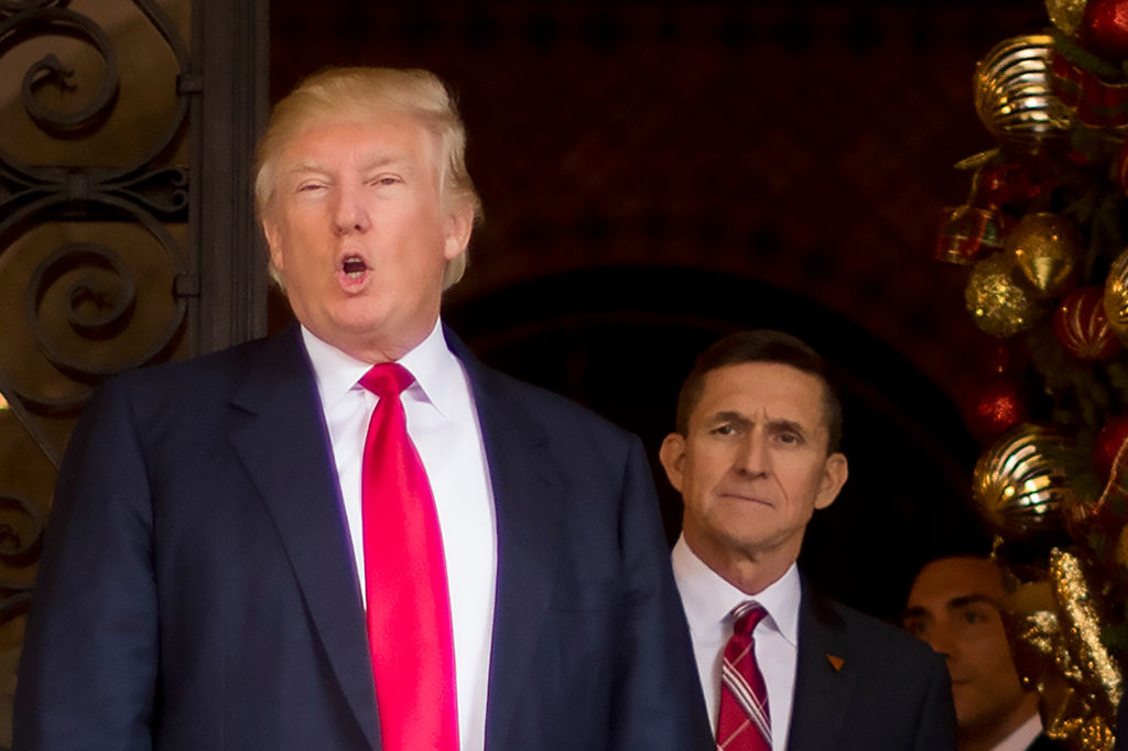 trump in a red tie with michael flynn, also in a red tie, behind him trump in a red tie with michael flynn, also in a red tie, behind him