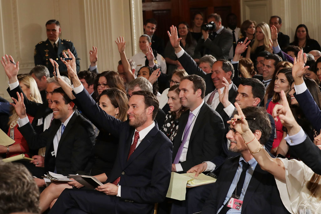 Reporters raise their hands to ask questions at a Trump press conference. Reporters raise their hands to ask questions at a Trump press conference.