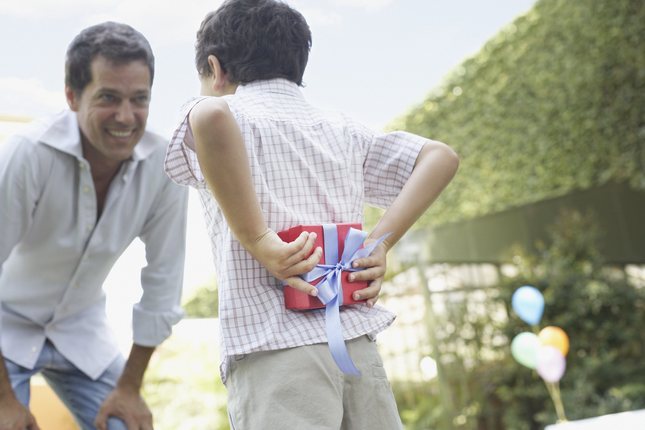 boy giving man gift
