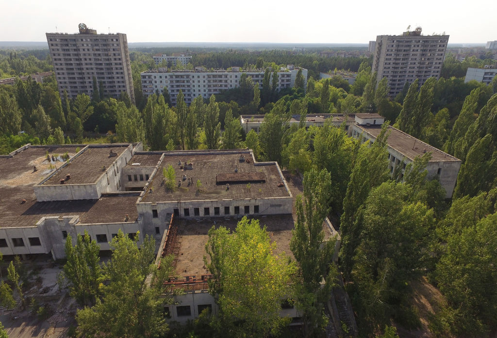 In this aerial view abandoned buildings stand near the main square in the ghost town of Pripyat not far from the Chernobyl nuclear power plant. In this aerial view abandoned buildings stand near the main square in the ghost town of Pripyat not far from the Chernobyl nuclear power plant.