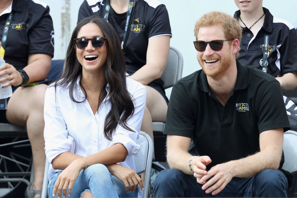 meghan markle in white and prince harry in black attend the Invictus Games