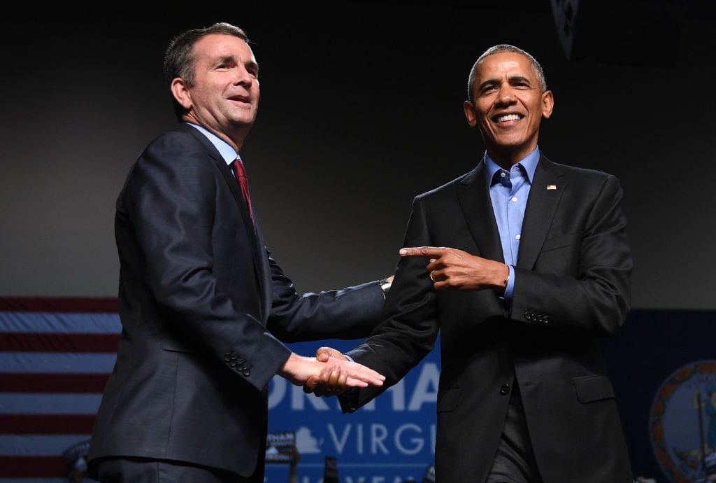 Ralph Northam in a dark suitshakes hands with Barack Obama in a dark suit Ralph Northam in a dark suitshakes hands with Barack Obama in a dark suit