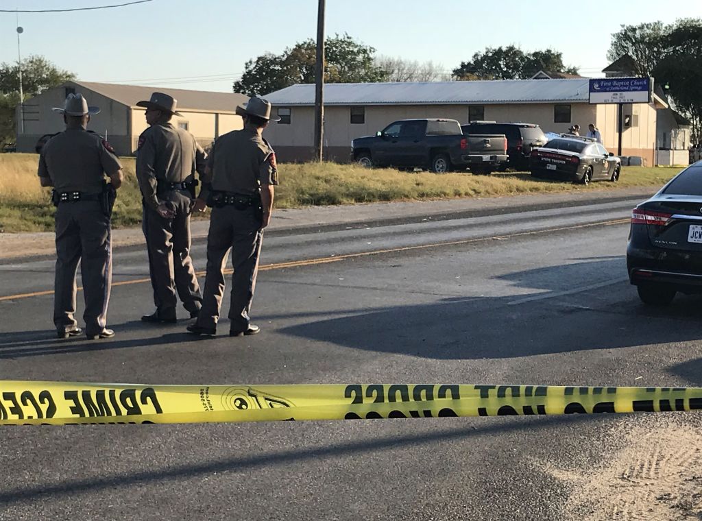police block a road with police tape in sutherland springs, texas