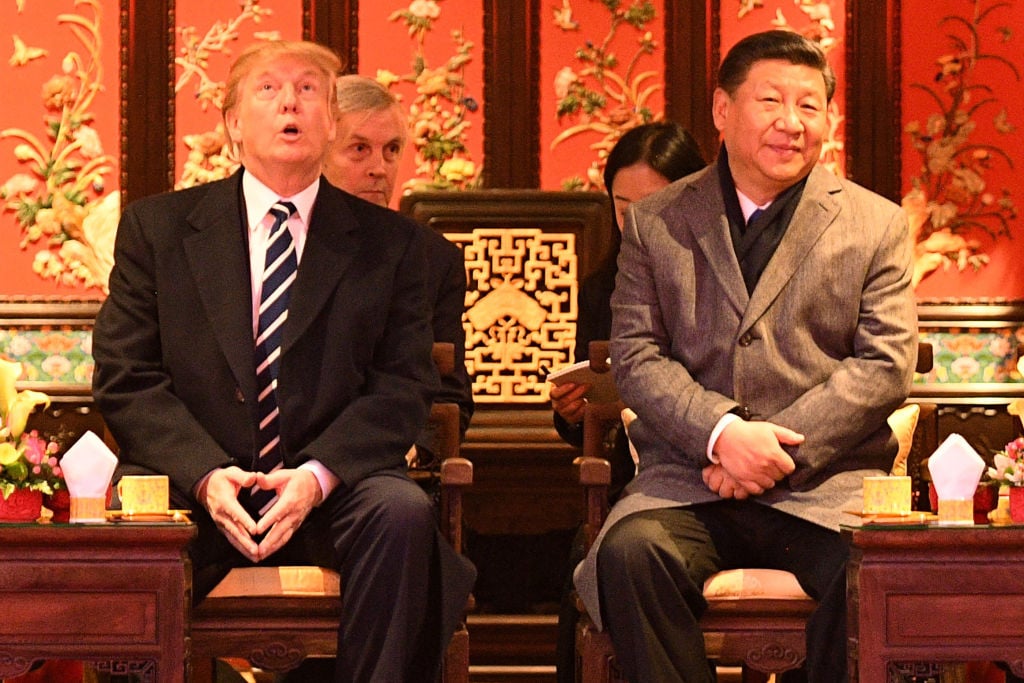 US President Donald Trump (L) looks up as he sits beside China's President Xi Jinping during a tour of the Forbidden City US President Donald Trump (L) looks up as he sits beside China's President Xi Jinping during a tour of the Forbidden City