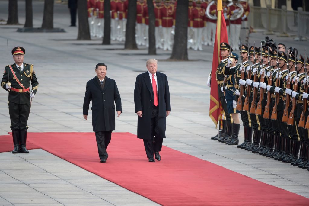 China's President Xi Jinping (2nd L) and US President Donald Trump review Chinese honour guards during a welcome ceremony at the Great Hall of the People in Beijing China's President Xi Jinping (2nd L) and US President Donald Trump review Chinese honour guards during a welcome ceremony at the Great Hall of the People in Beijing