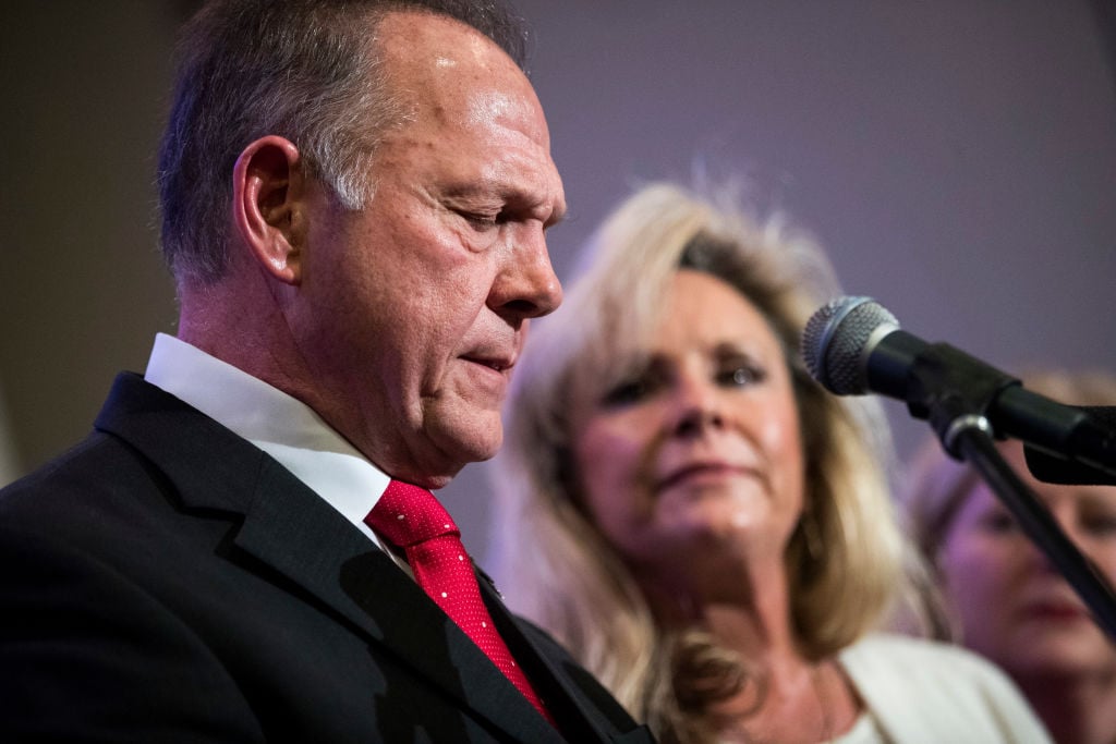 roy moore in a suit and red tie with kayla moore in white