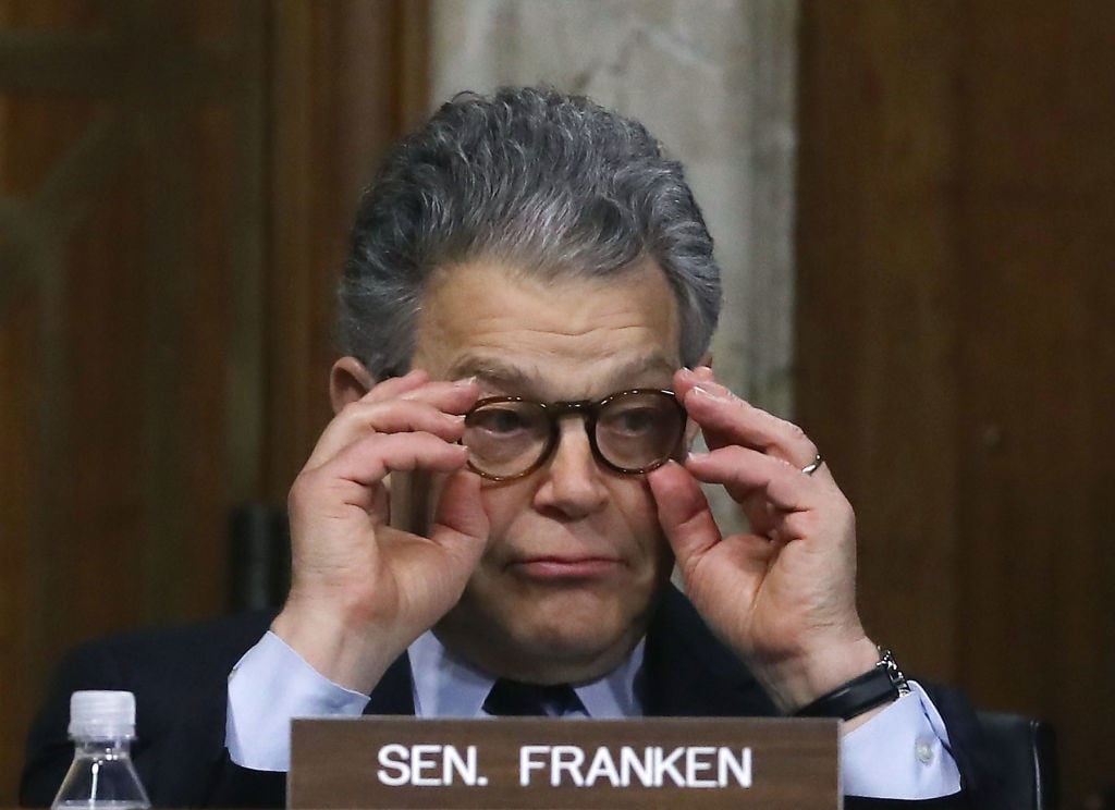 al franken adjusts his glasses behind his nameplate al franken adjusts his glasses behind his nameplate