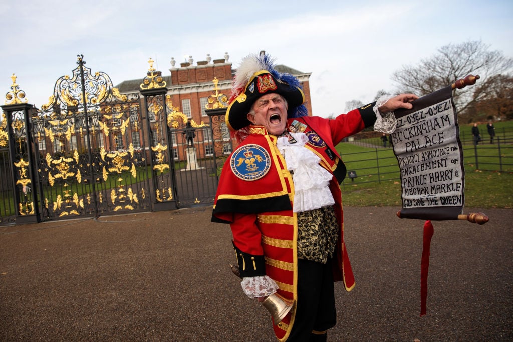 a costumed town crier outside kensington palace a costumed town crier outside kensington palace