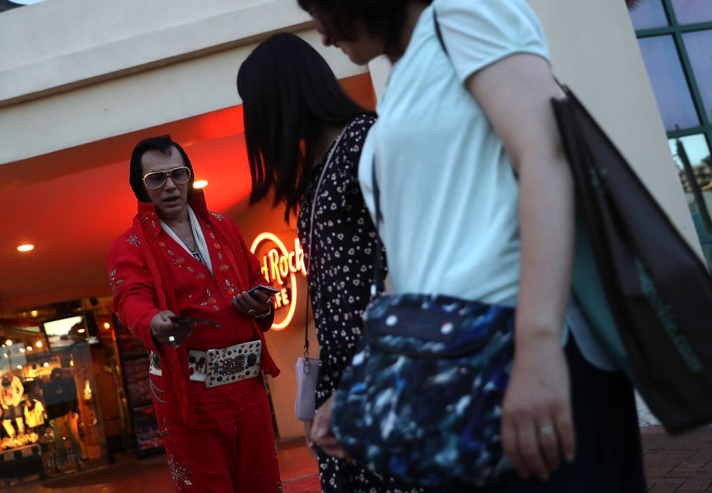 An Elvis impersonator hands out fliers in front of Hard Rock Cafe in Guam.