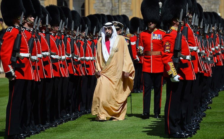 Sheikh Khalifa bin Zayed Al Nahyan walks past a row of armed guards. Sheikh Khalifa bin Zayed Al Nahyan walks past a row of armed guards.