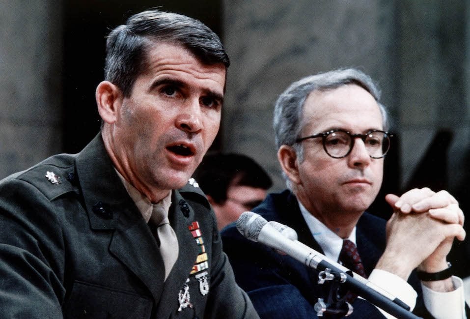 Lt. Col. Oliver North (L), accompanied by his lawyer