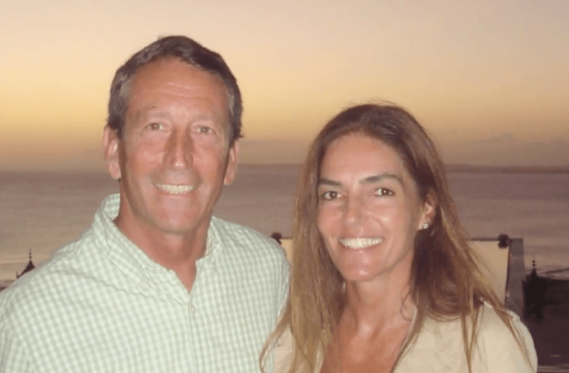 Mark Sanford and Maria Belen Chapur posing in front of a painting. Mark Sanford and Maria Belen Chapur posing in front of a painting.