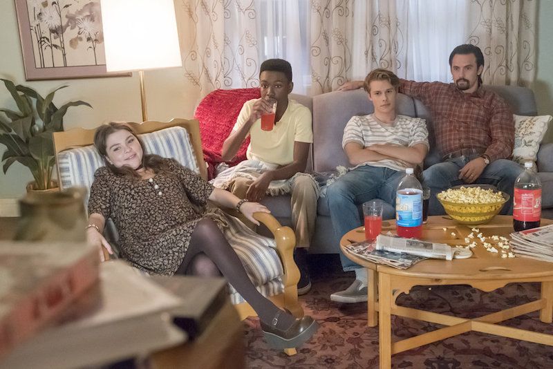 Three teens sit with their dad on a couch in This is Us