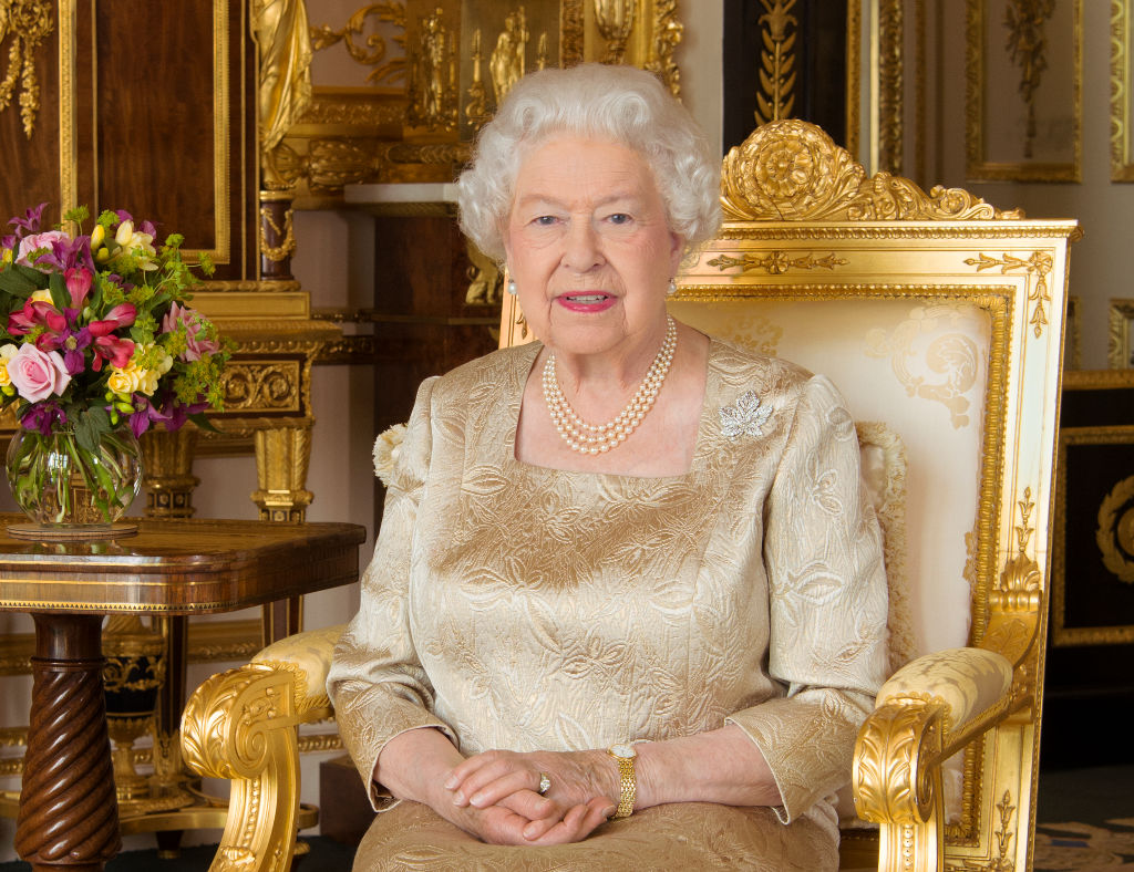 Queen Elizabeth sitting on a gold throne.