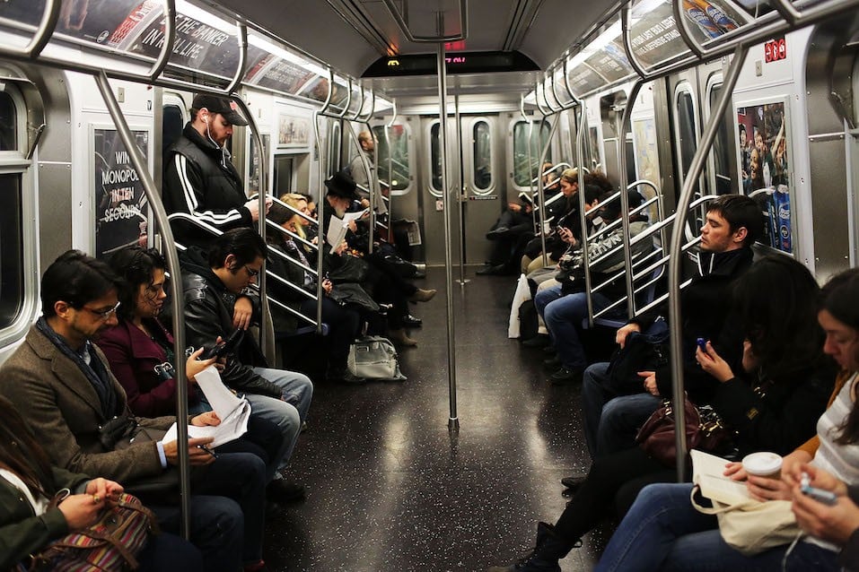 Passengers ride in a subway car two days after a man was pushed to his death in front of a train