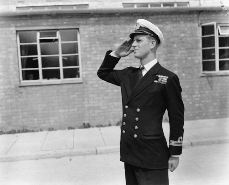 Prince Philip Mountbatten saluting in his uniform.