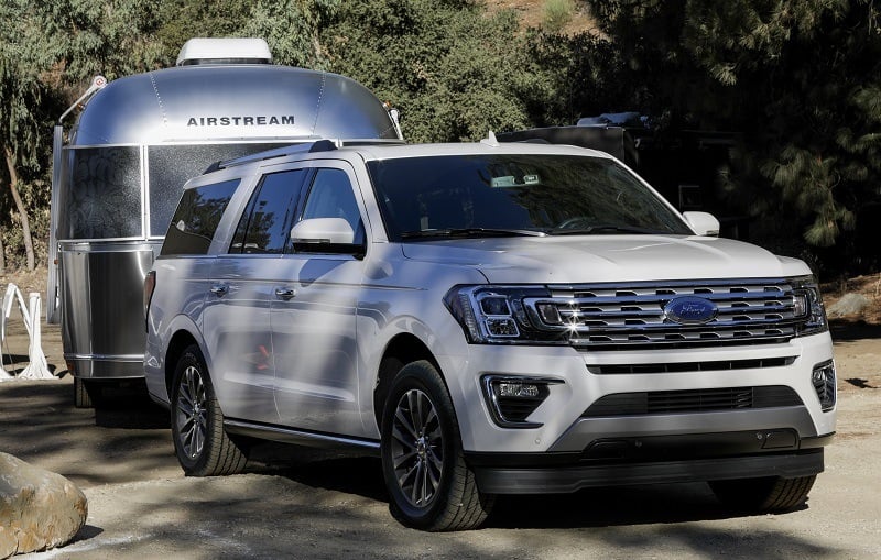 Shot of white 2018 Ford Expedition towing trailer